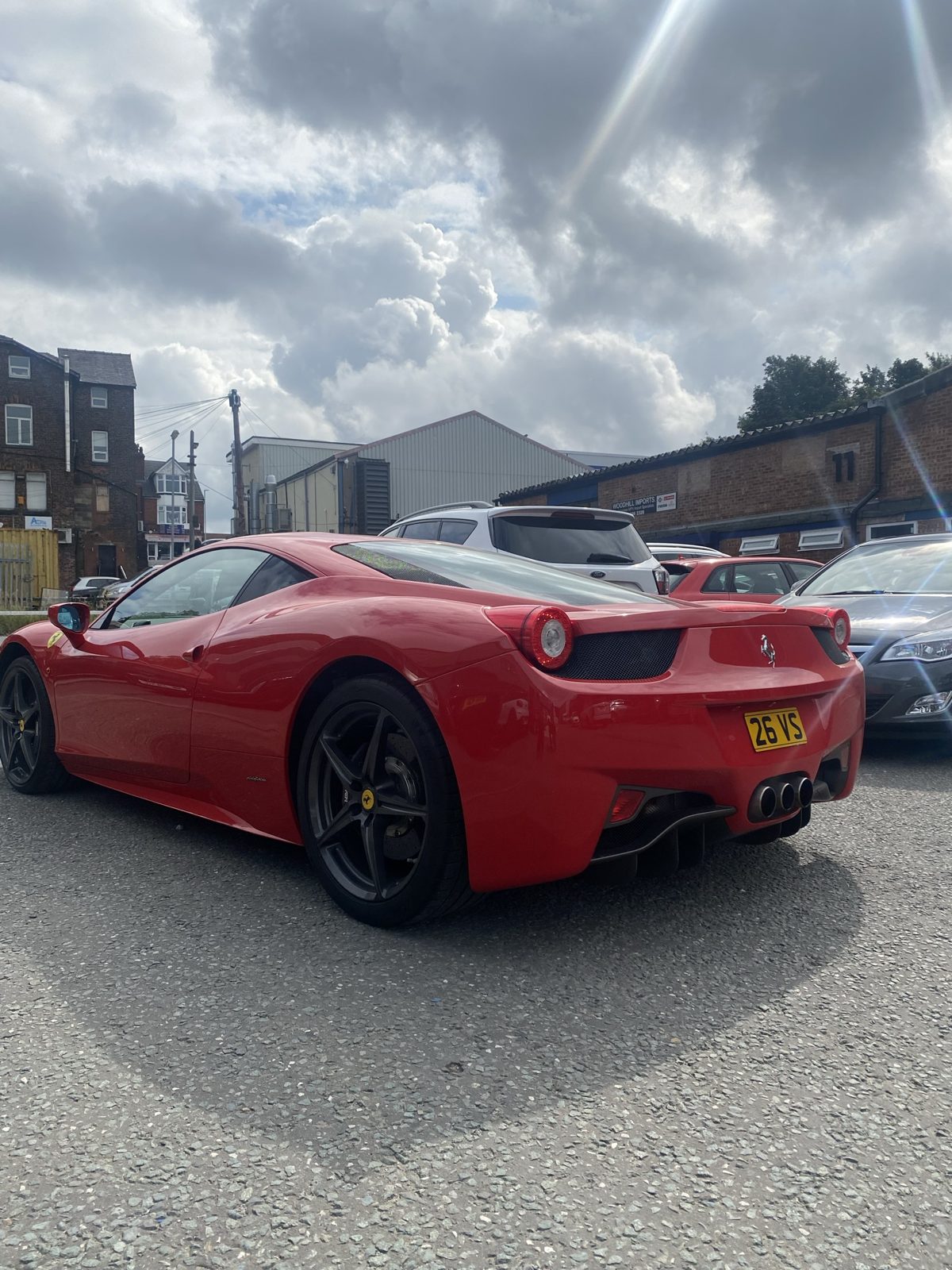 Rear three-quarter view of a red Ferrari