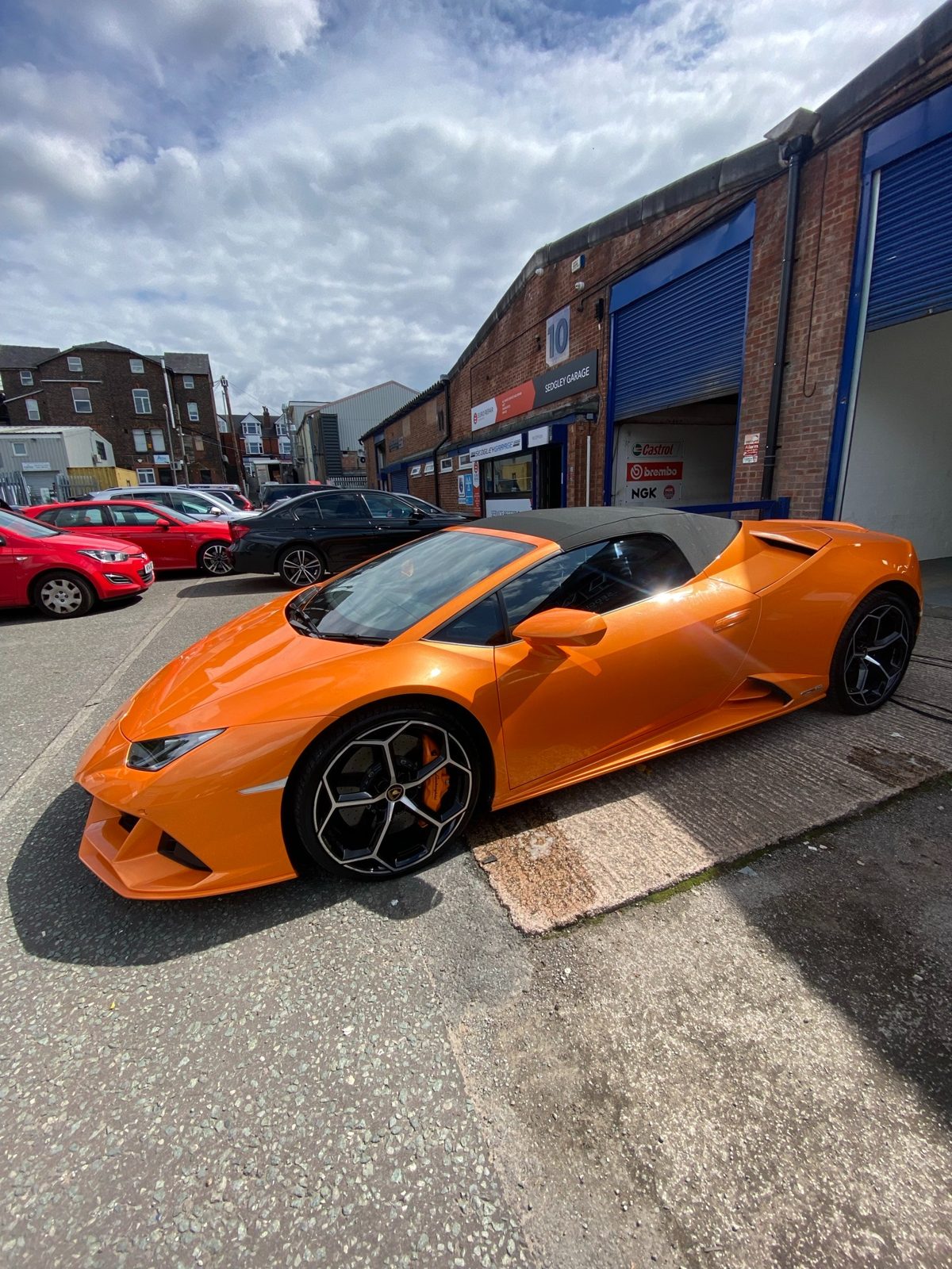 Rear three-quarter view of an orange Lamborghini
